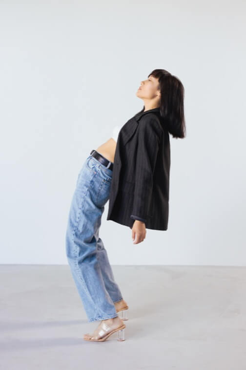 A woman is standing on a white wall