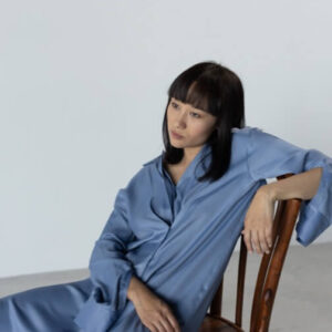 A woman is sitting on a chair in a room