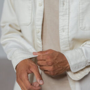 A man is holding a white piece of paper